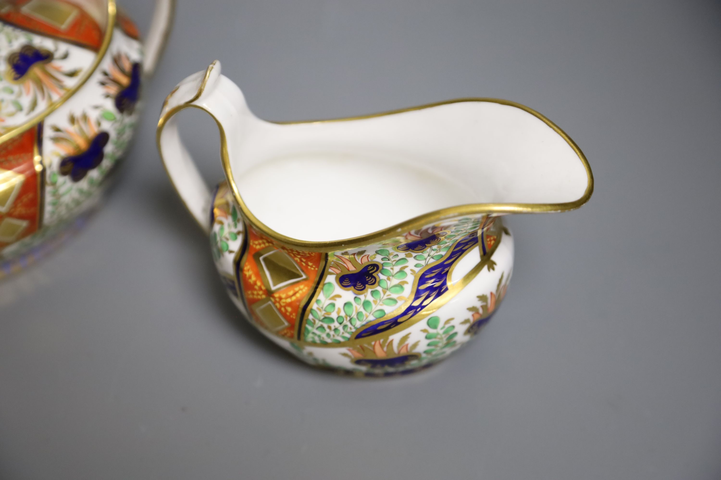 A Spode sucrier and cover painted in imari style with pattern 2213 and a matching 2213 cream jug